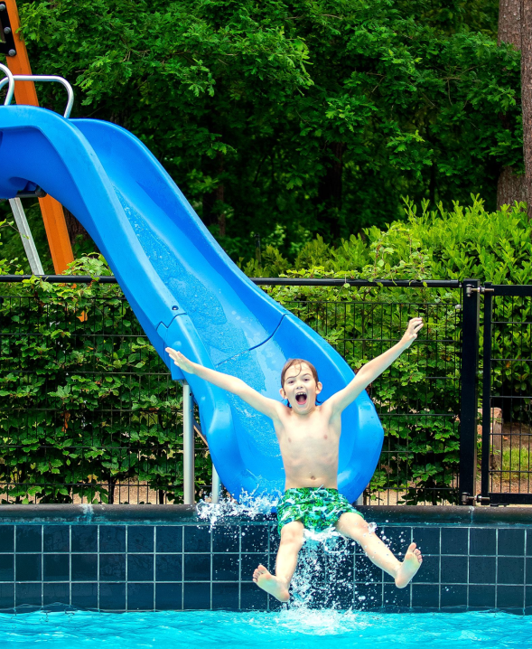 Jongen glijdend van de waterglijbaan